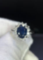 Silver ring with oval blue sapphire and diamond halo