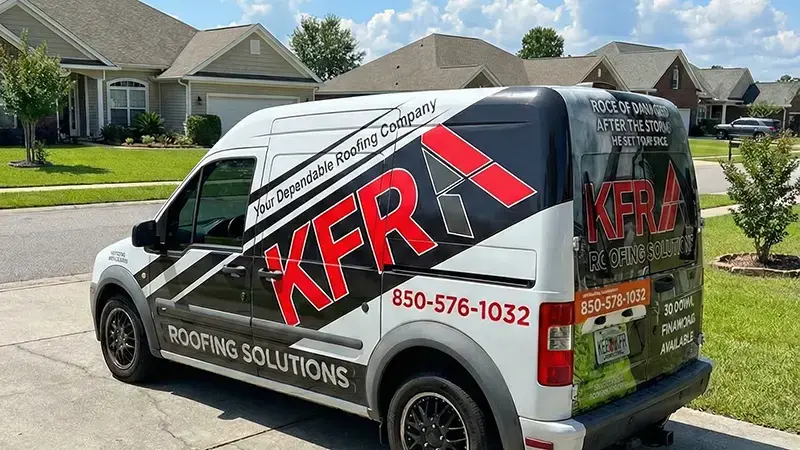 A KFR Roofing Solutions branded truck parked in front of a residential home