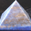 Thumbnail: A Blue Lapis pyramid, flecked with gold, is pictured above a black fabric.