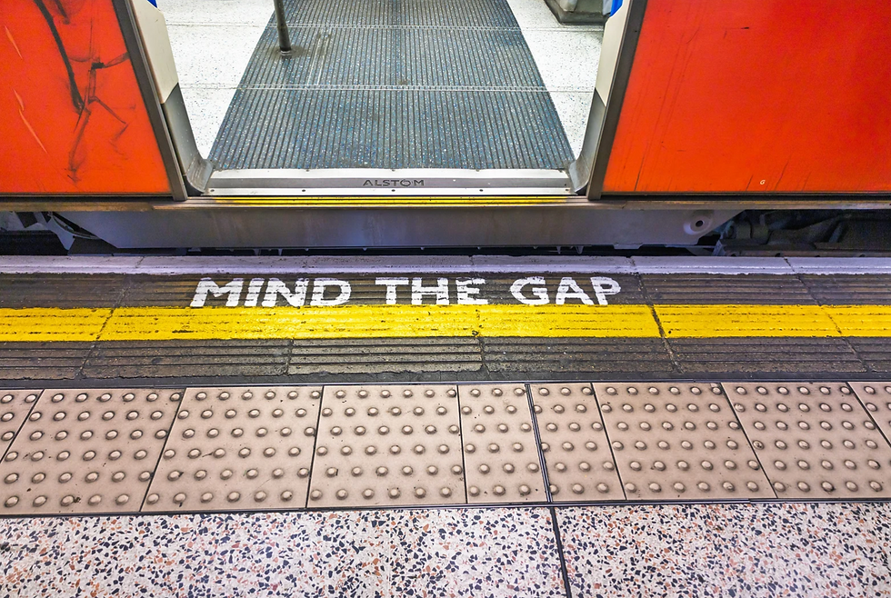 Photo of an open train door next to "mind the gap" written on the platform