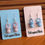 Thumbnail: Plastic pink and blue baby dummy earrings on backing card