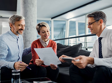 happy-couple-financial-advisor-going-through-plans-meeting.jpg