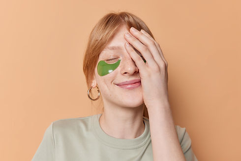pleased-ginger-freckled-teenage-girl-covers-half-face-with-palm-keeps-eyes-closed-undergoe