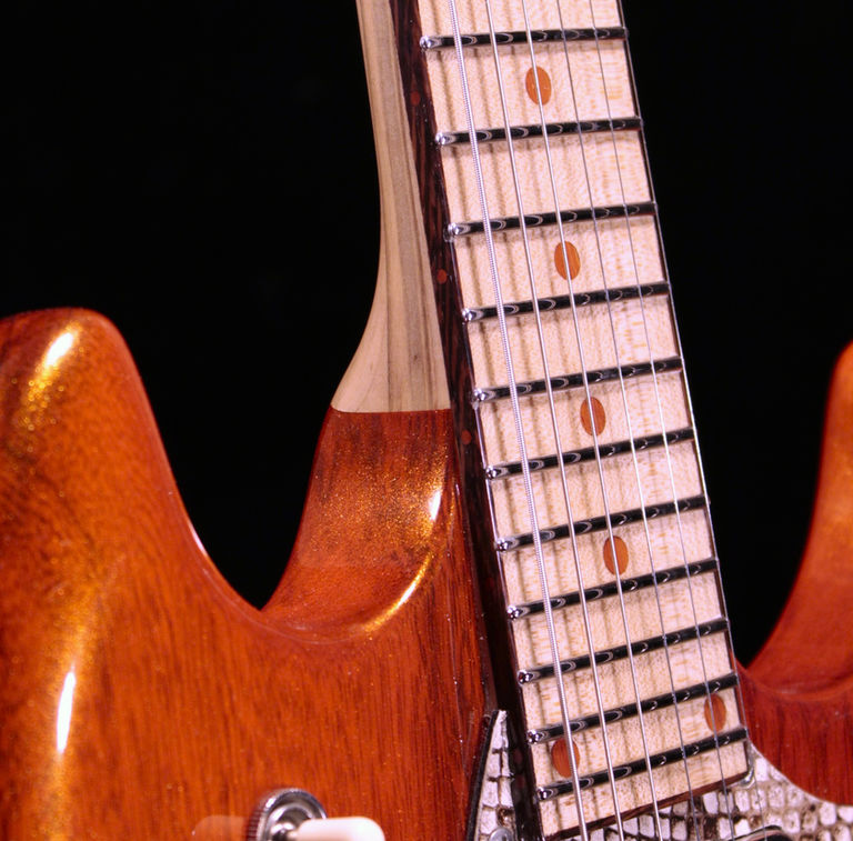 EA 24 Translucent fire orange guitar front of with ambrosia maple wenge & graphtech ratio locking tuning keys body only close up of frets stainless steel jumbo with hemispherical ends