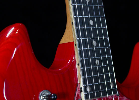 EA 24 Translucent ruby red guitar front close up of fret ends stainless steel jumbo hemispherical ends