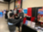 Photo of Pete Sullivan standing at RV on Call booth at Raleigh RV trade show in 2023