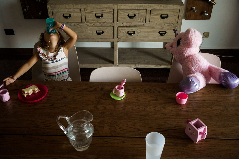 girl having tea with her unicorn