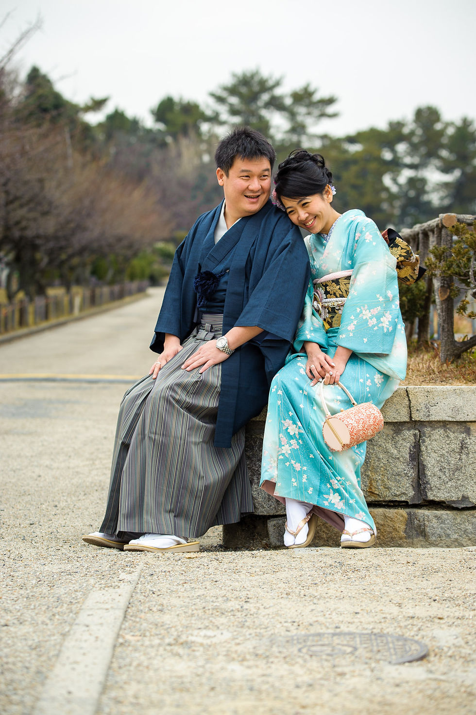 Carina and Very smile and laugh as they sit together in front of the castle in their kimonos