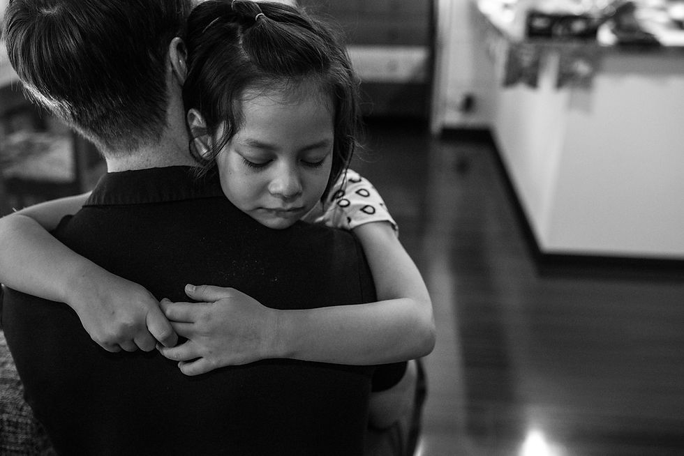 Eve cries on her dad's shoulder