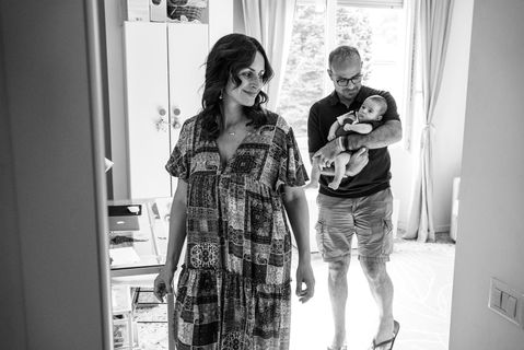 dad holds baby and follows mom out of nursery