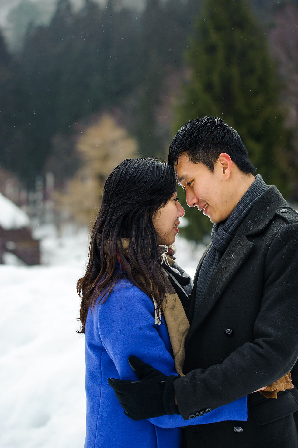 Sin looks lovingly at his fiancée in Shirakawago