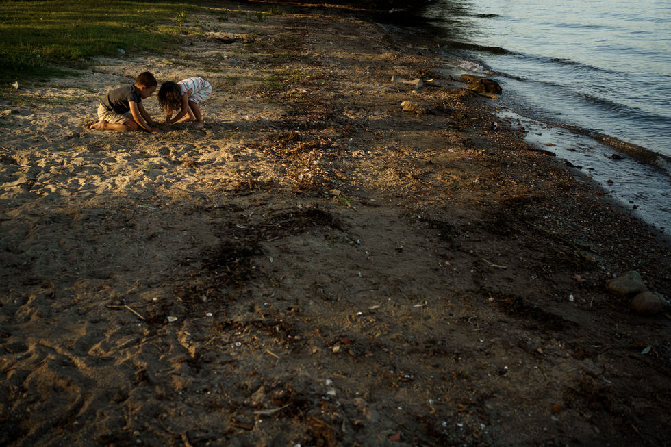 kids playing on the lake beach