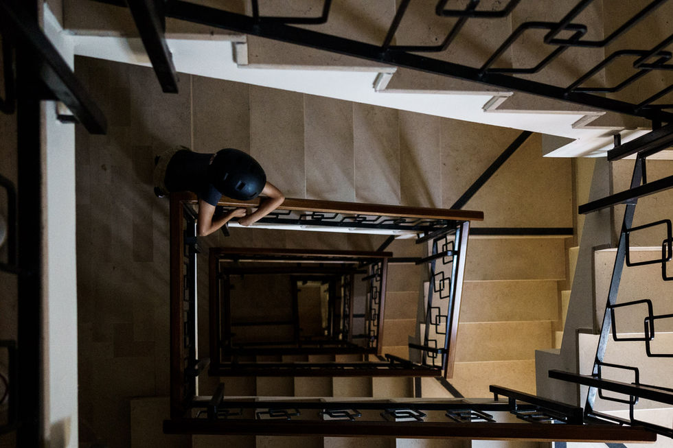 boy leaning on the stair rail