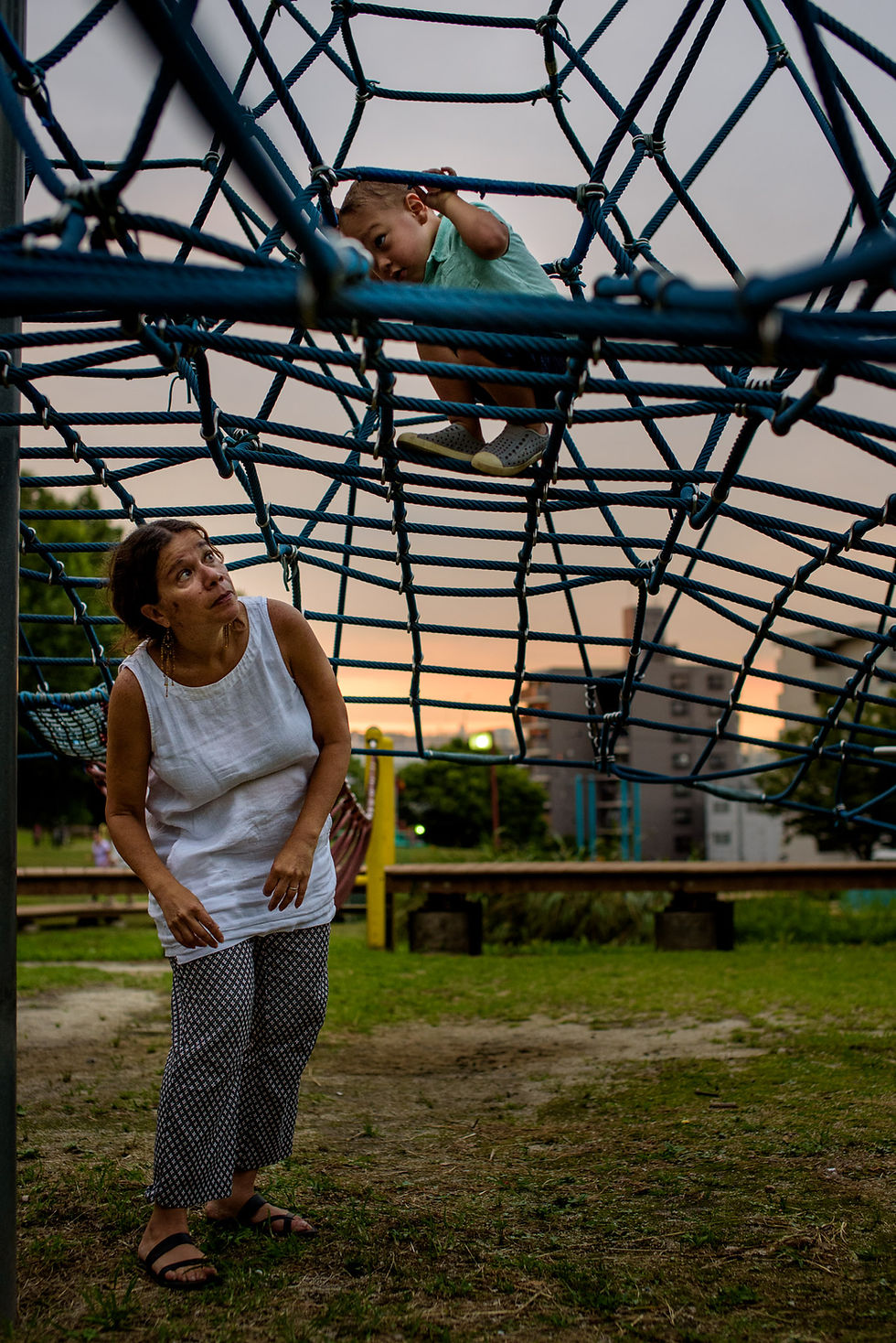grandma watches her grandson nervously on the playground
