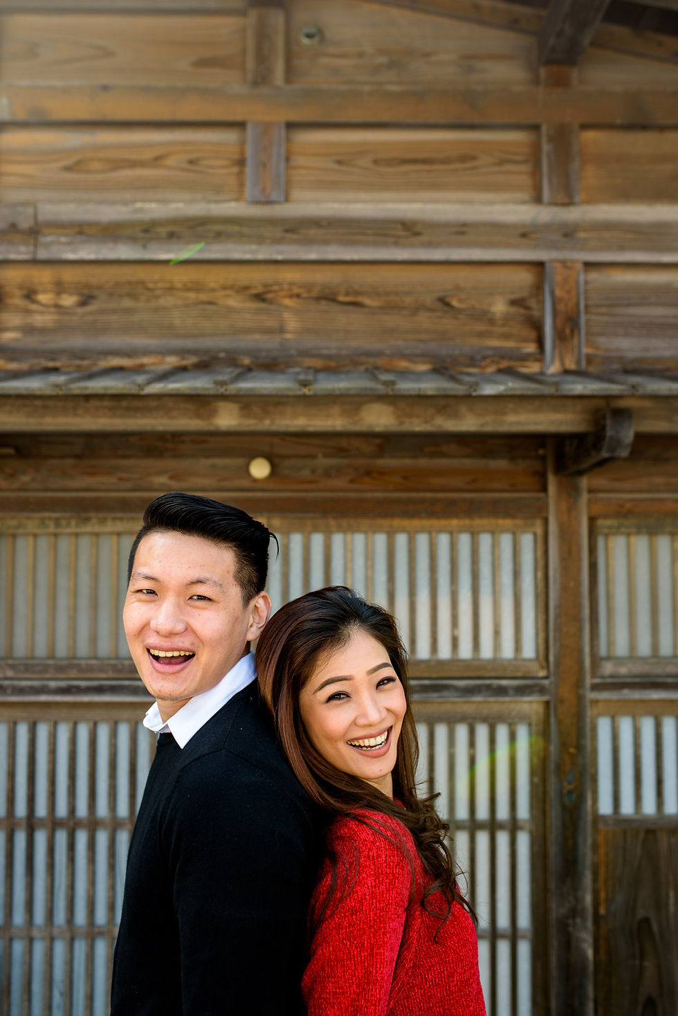 Vivi and Mika in front of the wooden building