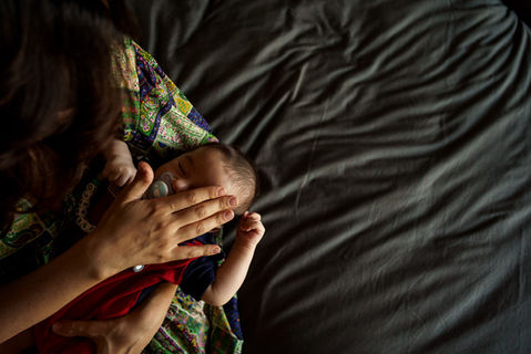 mom touches her baby's forehead
