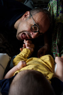 dad pretends to eat the baby's toes