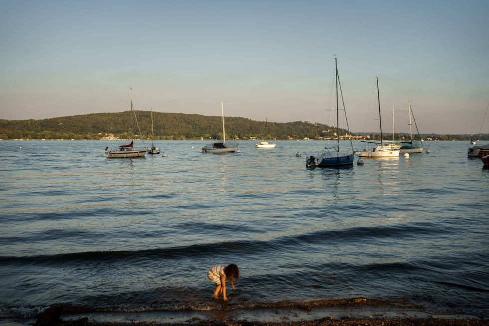 girl plays in the water at the lake beach