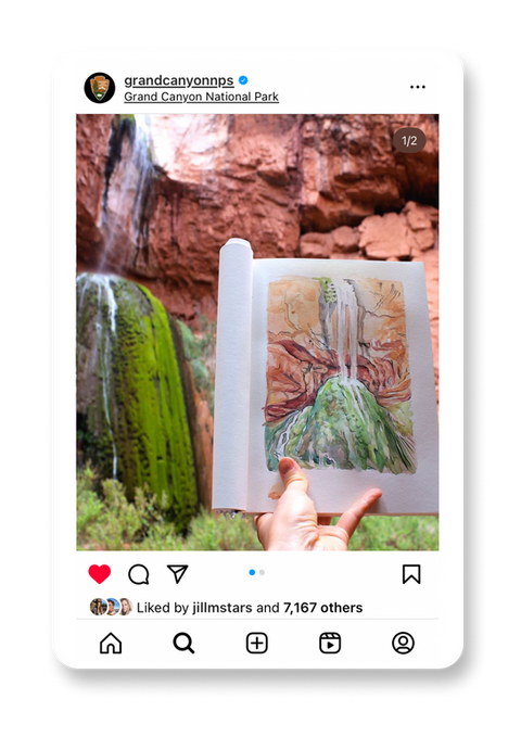 A hand holding an open sketchbook with a watercolor painting of a lush waterfall surrounded by moss-covered rocks. Behind the sketchbook, the actual waterfall flows gracefully against a backdrop of red canyon walls, capturing the artist's inspiration. The image sits within a frame of an instagram post from the Grand Canyon National Park.