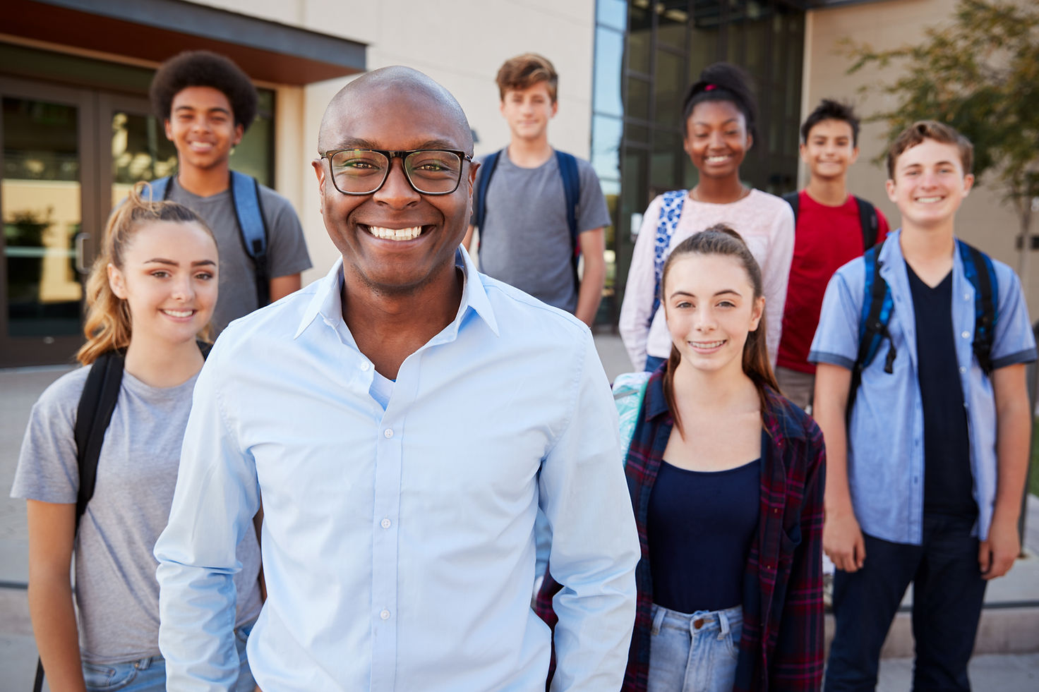 Portrait Of High School Students With Teacher Outside College Buildings.jpg