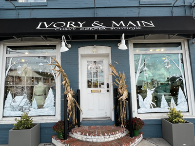 Ivory & Main Curvy Corner Boutique store front with windows decorated like a winter wonderland