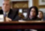 In this December 17, 2009 photo, Elouise Cobell, right, looks on as Deputy Secretary of the Interior David Hayes testifies during a Senate Indian Affairs Committee hearing in Washington, D.C. Native Americans who sued the federal government over lost royalties have been waiting nearly 15 years for the $3.4 billion settlement Congress passed that year. (AP Photo/Evan Vucci, File)