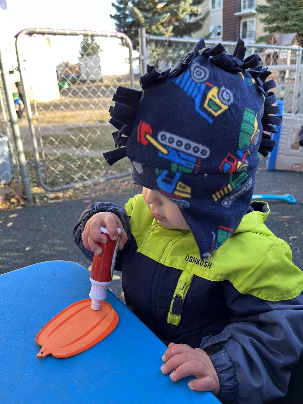 Our infants creating art outside