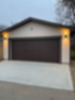A garage with a brown shutter door