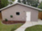Front of a house with empty ground around it