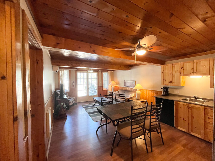 Dining table with the living room in the background