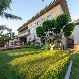 Best Western Plus Anaheim exterior with garden and sign.