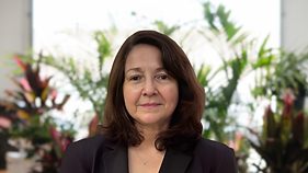 Woman with shoulder-length brown hair and dark blazer