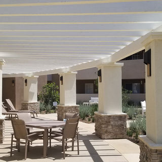Outdoor shaded patio with seating at Heritage Pointe.