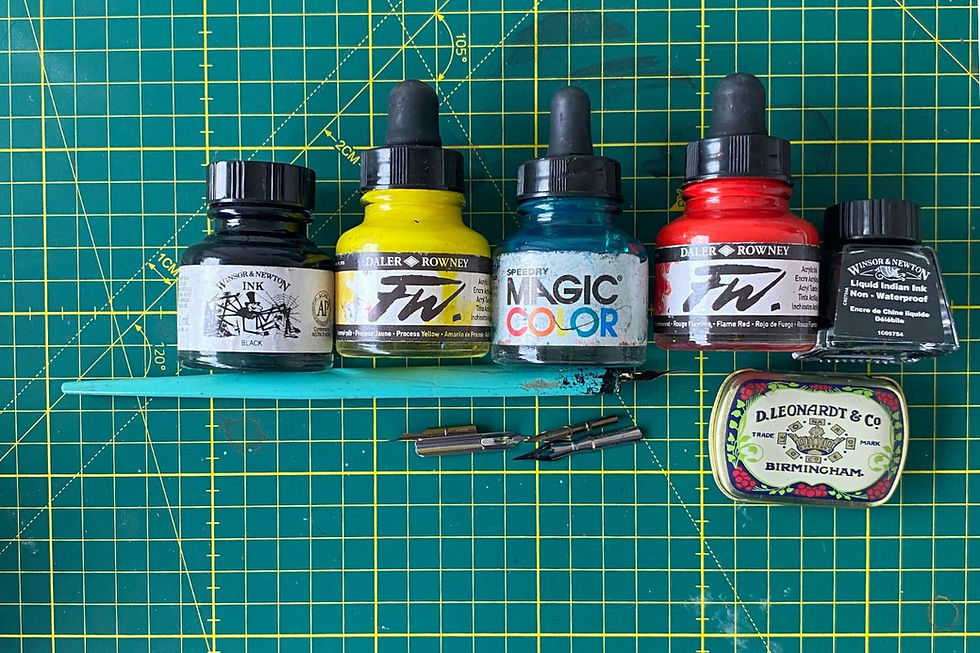 My acrylic ink and drawing inks, alongside my trusty dip pen and a few nibs.