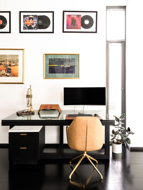 A interior design photograph with a desk and workstation with artwork hanging on the wall