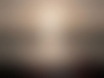 The fire of a rocket launch hovers over a launch site and is reflected in the water.