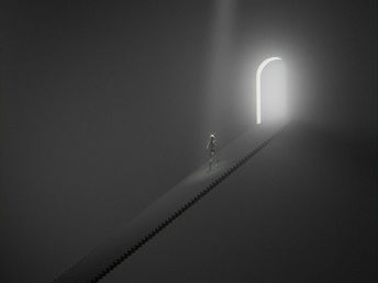 A person in a dimly lit expanse climbs a staircase toward an open door illuminated from beyond.