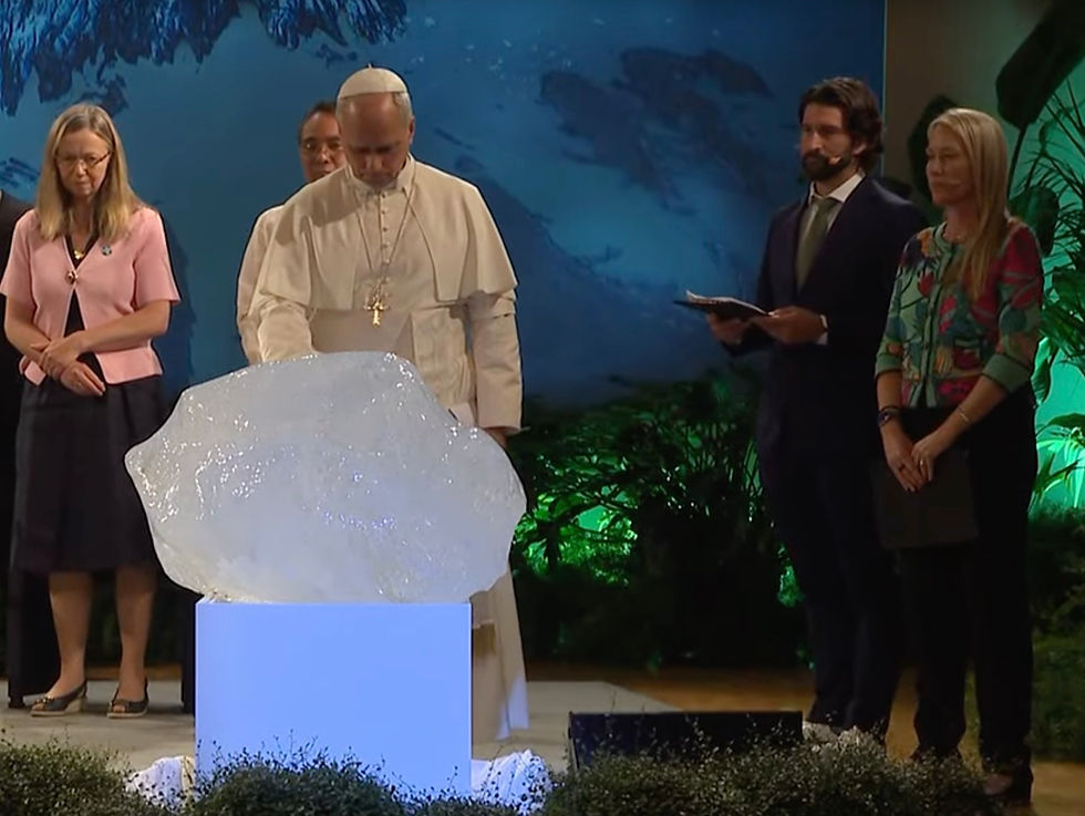 Pope Leo lays his right hand on a rough block of ice.