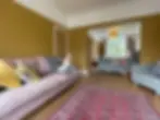 victorian living room with mustard yellow walls and white woodwork and ceiling