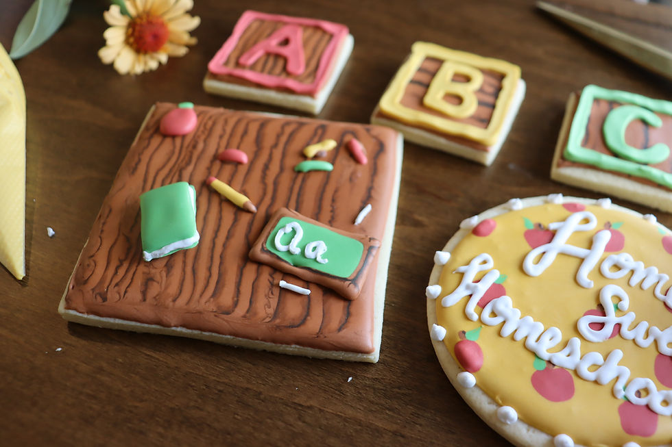 Back-to-school sugar cookies with fondant decorations, including apples, letters, and a chalkboard scene.