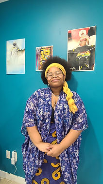 Leah Sarai standing against a teal background