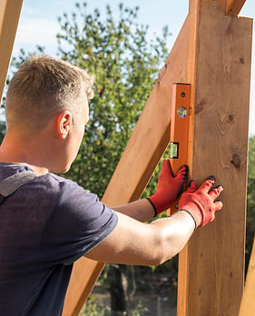 carpenter-man-taking-measures-wood-plank.jpg