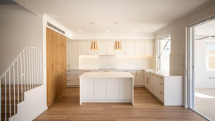 a variety of textures and materials, like wood, rough stone, and warm porcelain, to create a space that feels balanced