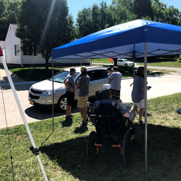 Sitting outside under a cover.