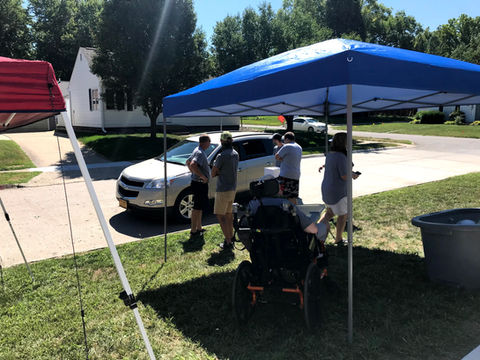Sitting outside under a cover.