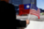 A supporter holds the flags of the U.S. and Taiwan