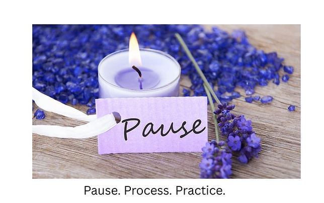 purple candle and flowers with a small tag that says pause