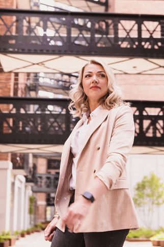 business woman wearing semi casual clothing walking in a metropolitan environment