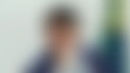 Esta imagem mostra Tarcísio de Freitas, atual Governador do estado de São Paulo, em um evento oficial com a bandeira do Brasil ao fundo.