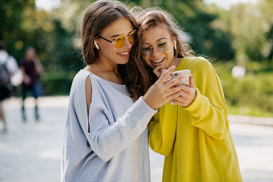 pretty-charming-lady-in-stylish-glasses-is-holding-smartphone-and-talking-with-friends-on-
